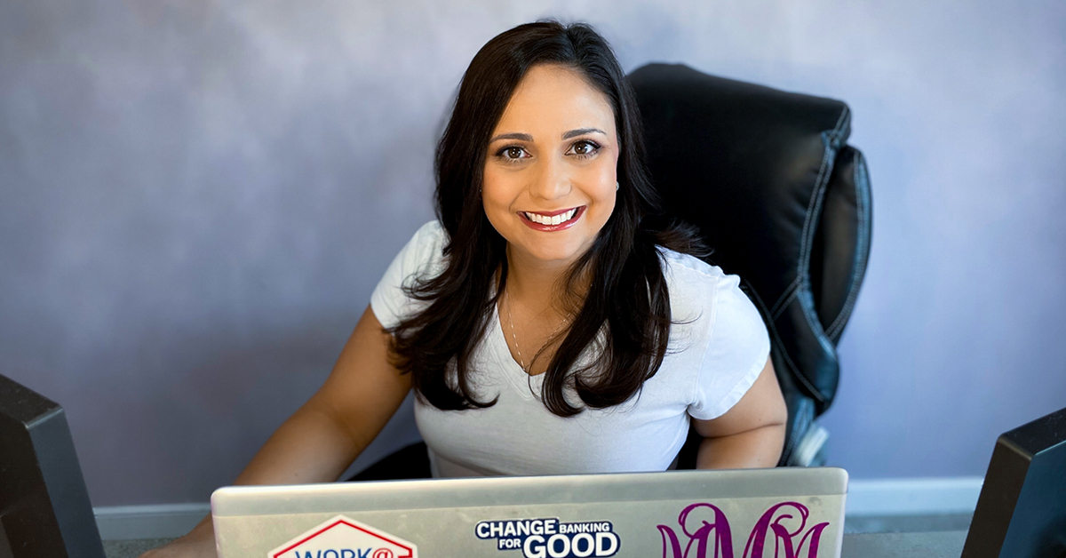 Maris, Capital One associate, sits in her remote office chair with her laptop. She has worked from home for nearly 11 years.  