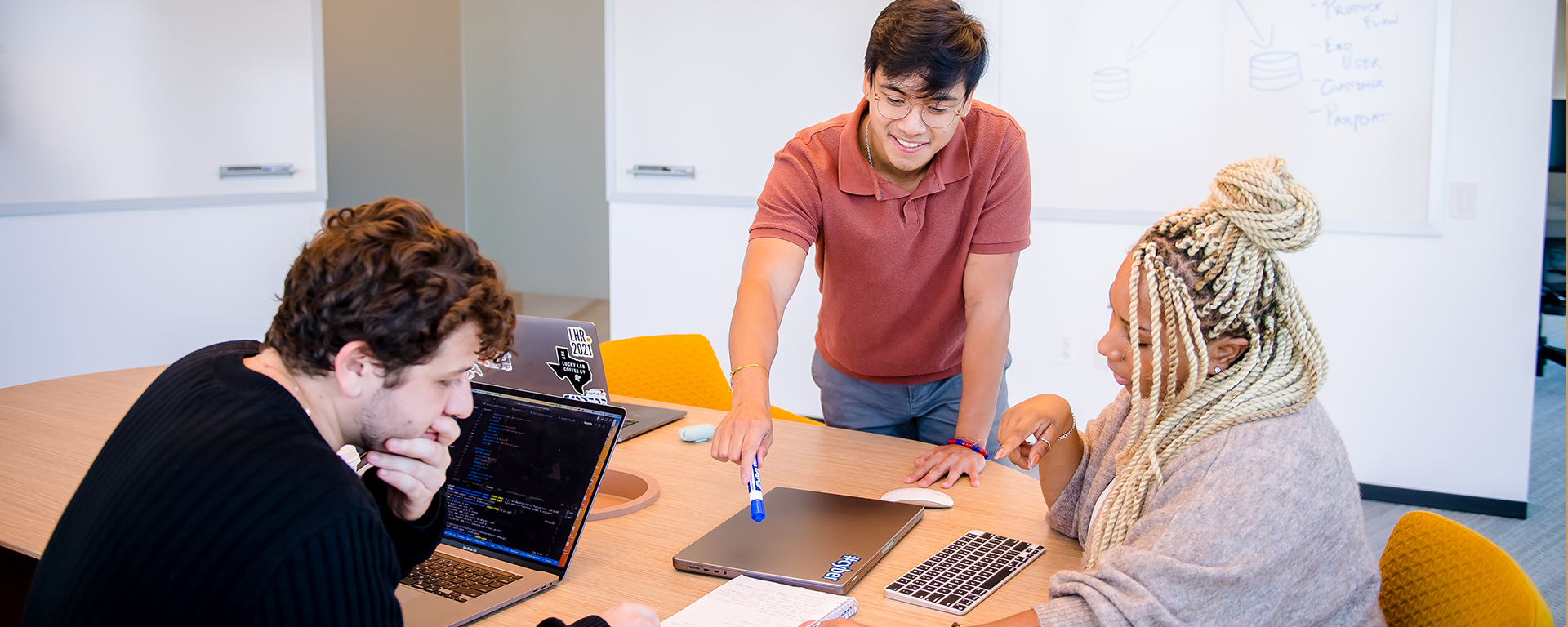 Three Capital One associates collaborate around a table
