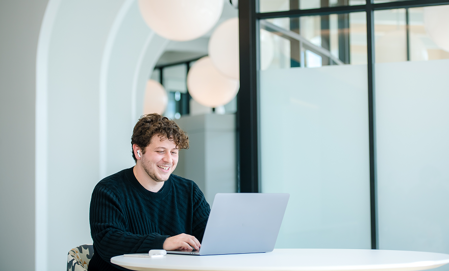 associate working on laptop in office